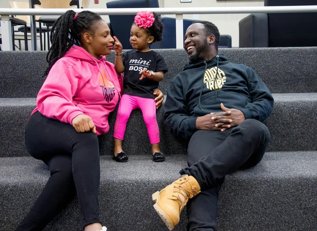 A young family sitting together and laughing
