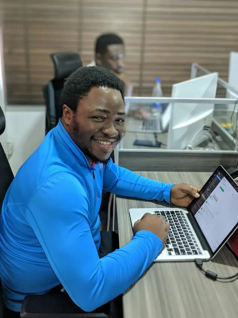 A church admin smiling at his laptop