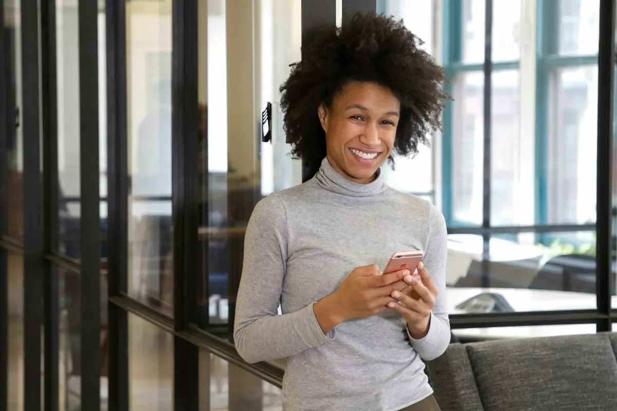 A church member smiling at her phone