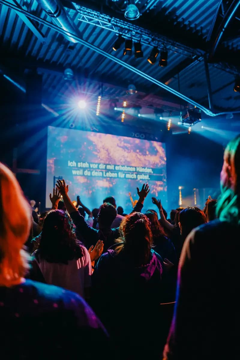A congregation worshipping with hands raised