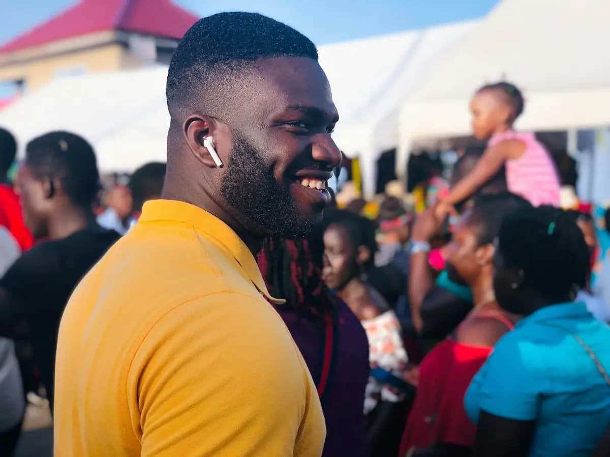 A smiling man among his church family at a service